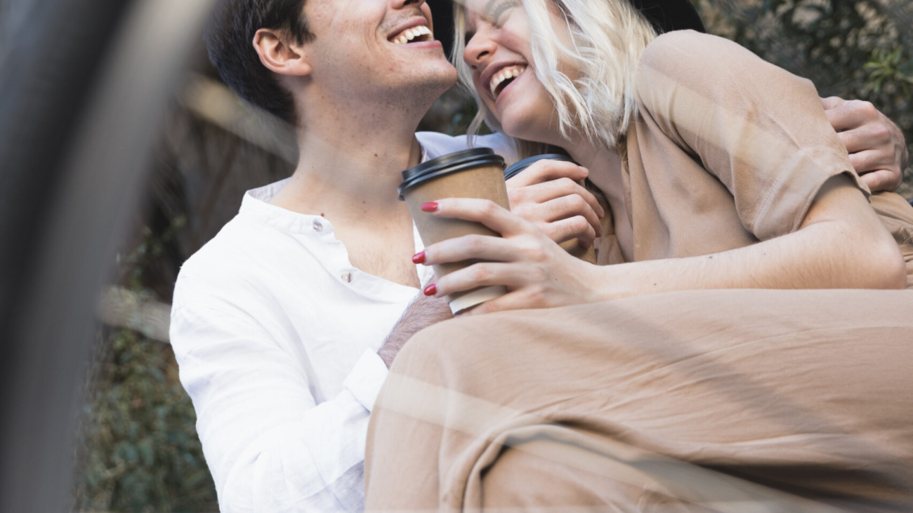 low-angle-happy-couple-bench