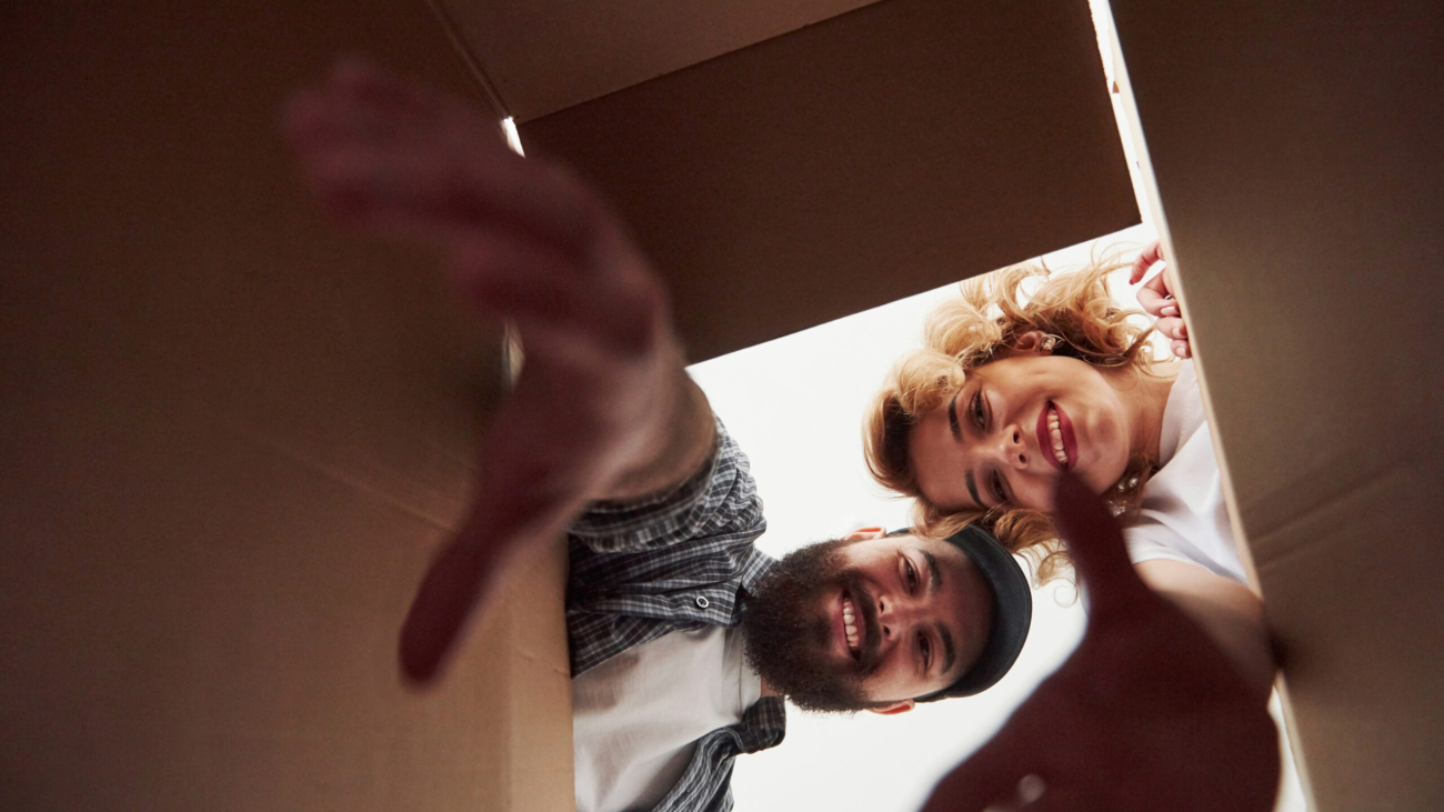 With elongated hands. Happy couple together in their new house. Conception of moving.