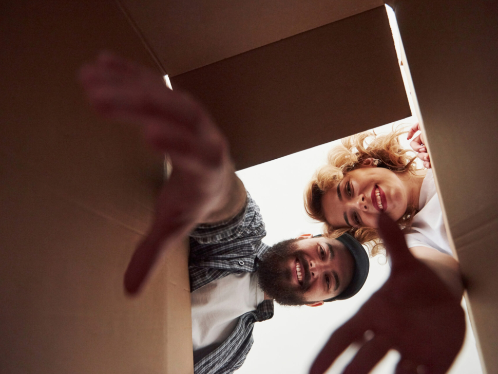 With elongated hands. Happy couple together in their new house. Conception of moving.